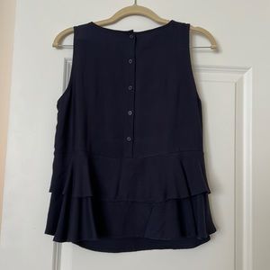 Navy blue sleeveless blouse with accent buttons on back.